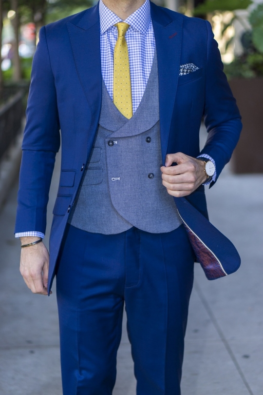 What color shirt looks best on the blue suit?
